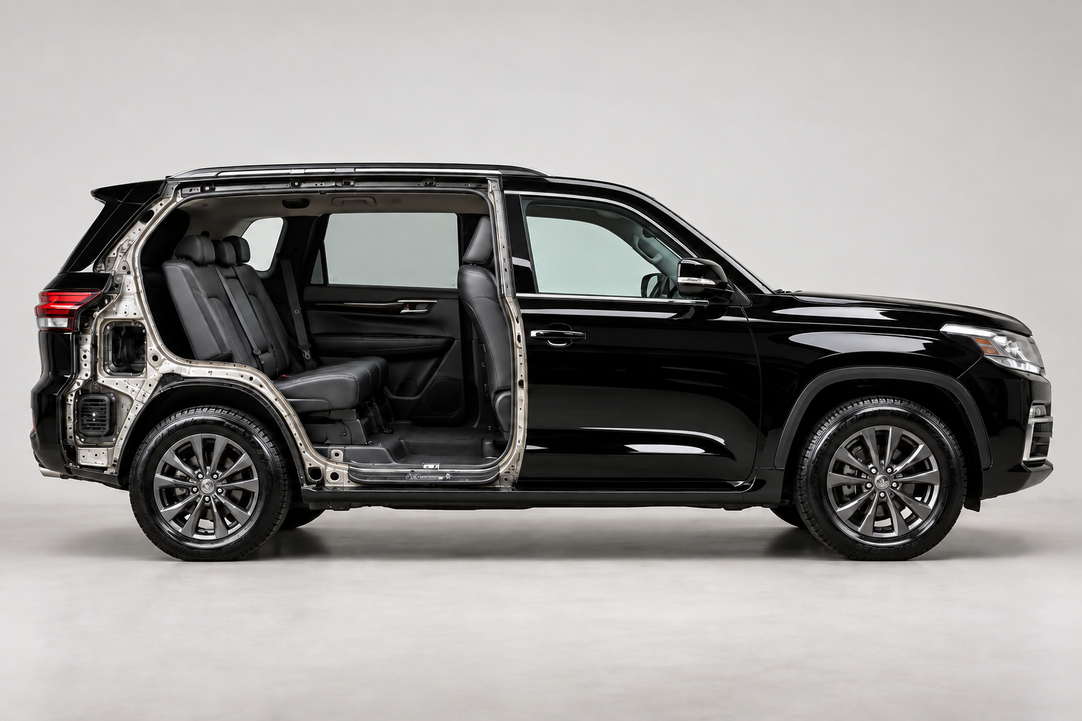 The same black SUV cutaway after detailing, with clean windows, seats, floors, tires and a waxed exterior